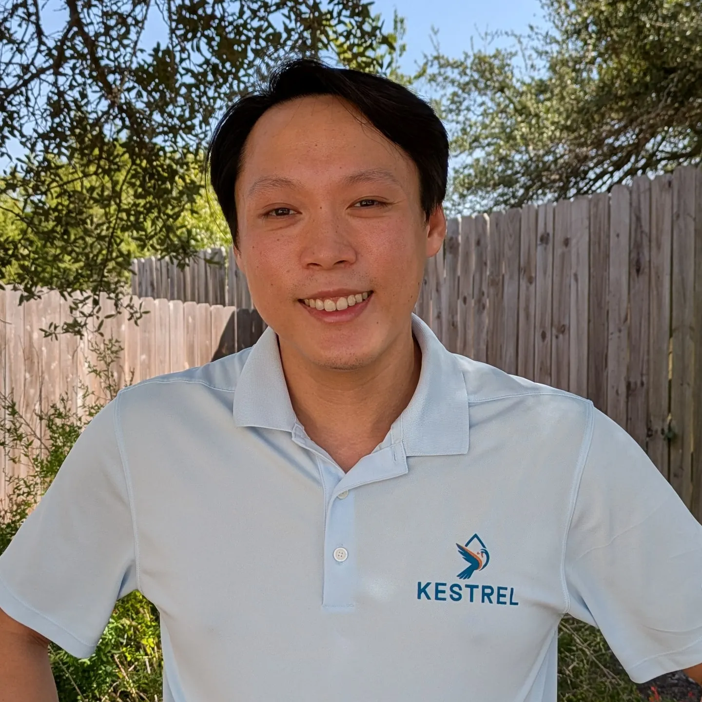 Ji, the owner of Kestrel Pool Services, in a Kestrel polo
